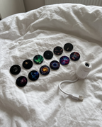 Several round sky projection discs spread out on a white duvet