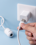 Plugging the projector's USB cable into a charger