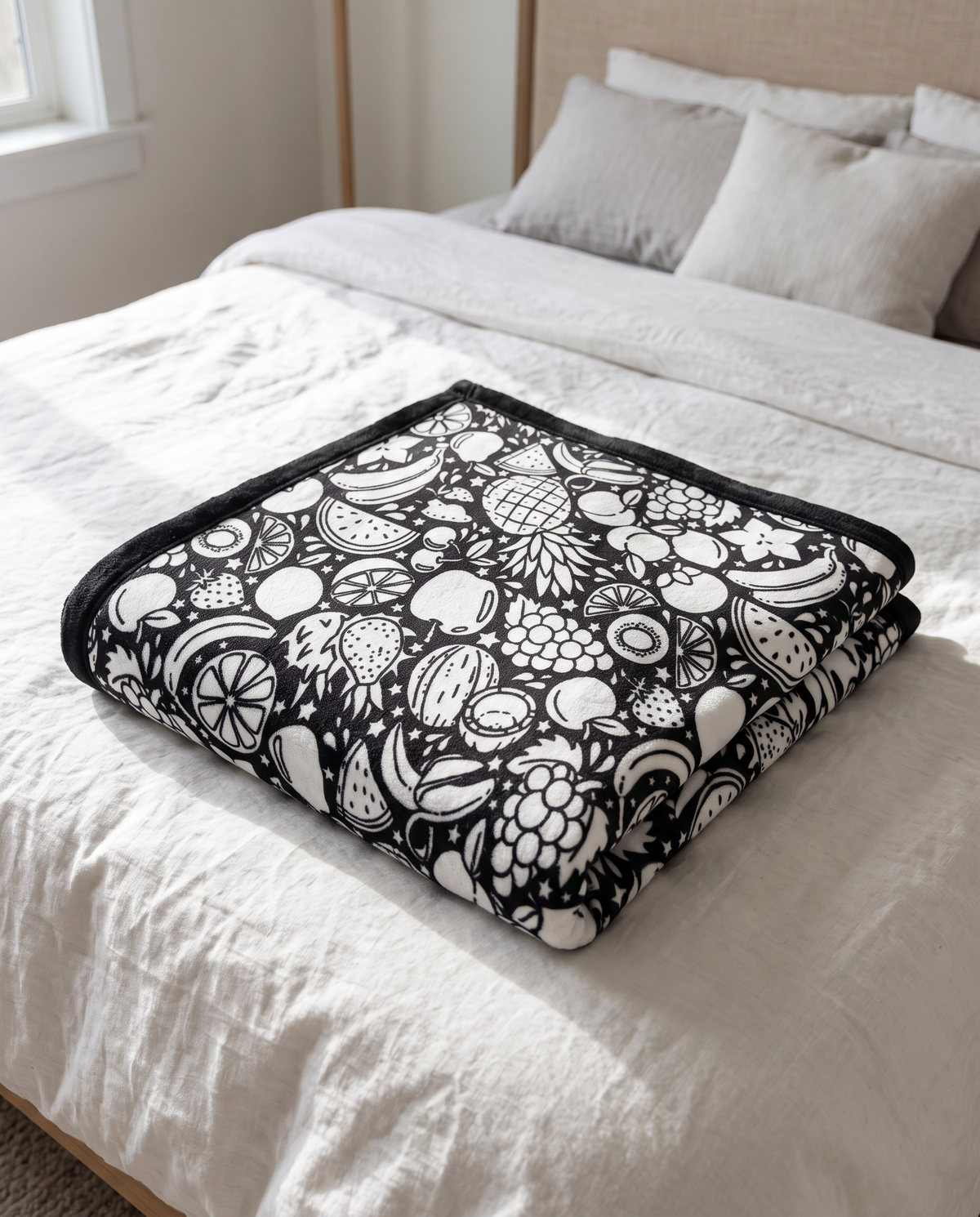 Fruit Party design coloring blanket folded on a bed