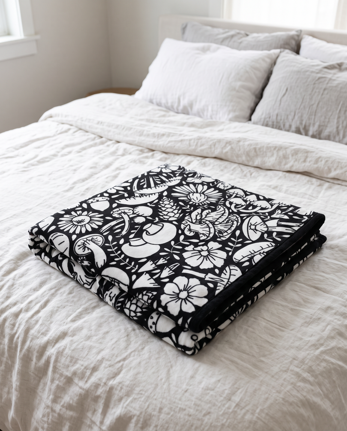 Mushroom Garden design coloring blanket folded on a bed