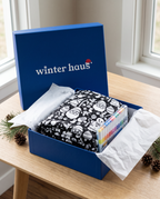 The coloring blanket and markers in the cobalt-blue Winter Haus gift box